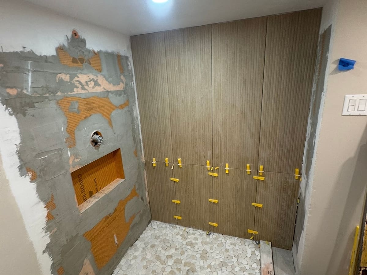 Shower wall tile going up with spacers