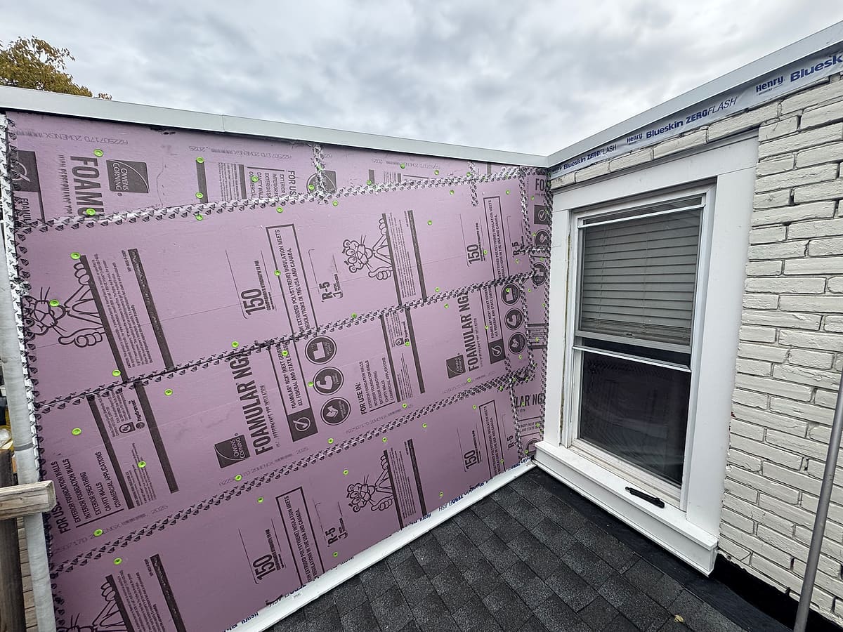 House wrapped in foam board before siding