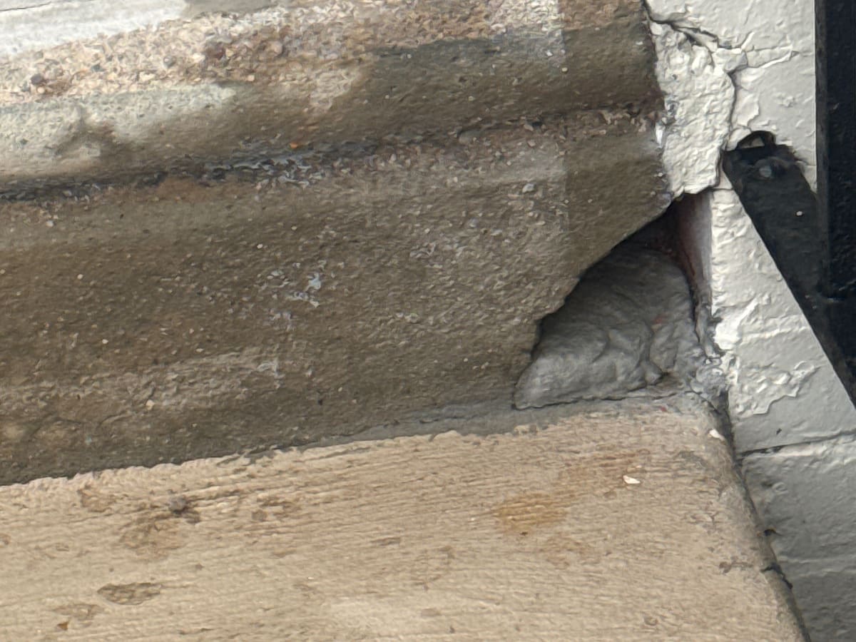 Cracked, crumbling concrete front step