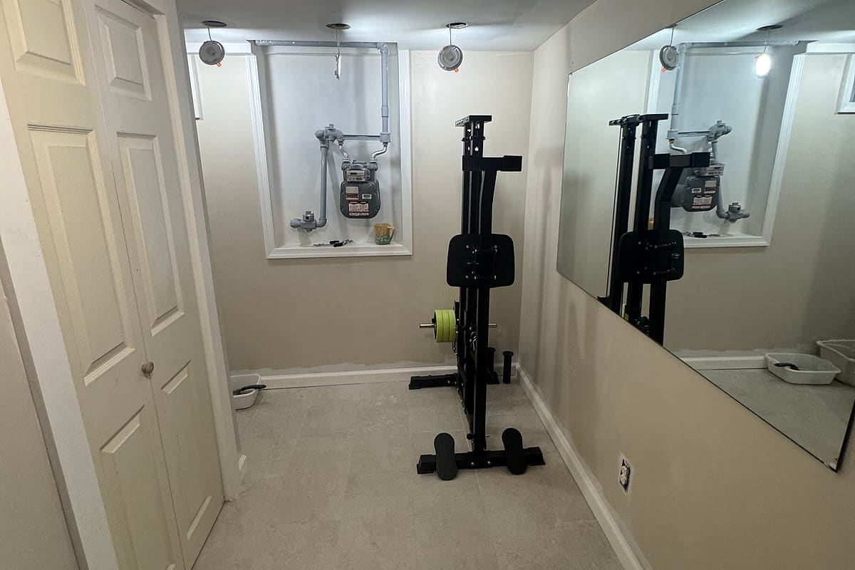 Finished basement room with fresh drywall, paint and new flooring